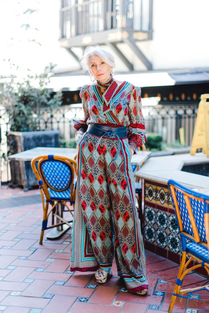 Woman wearing print palazzo pants and top for the spring travel capsule wardrobe edit with Alice and Olivia