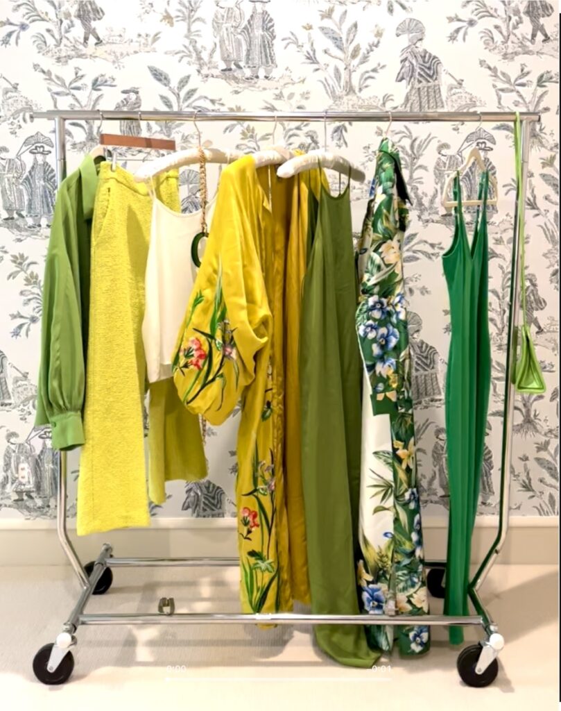 hanging wardrobe rack with green and yellow clothes