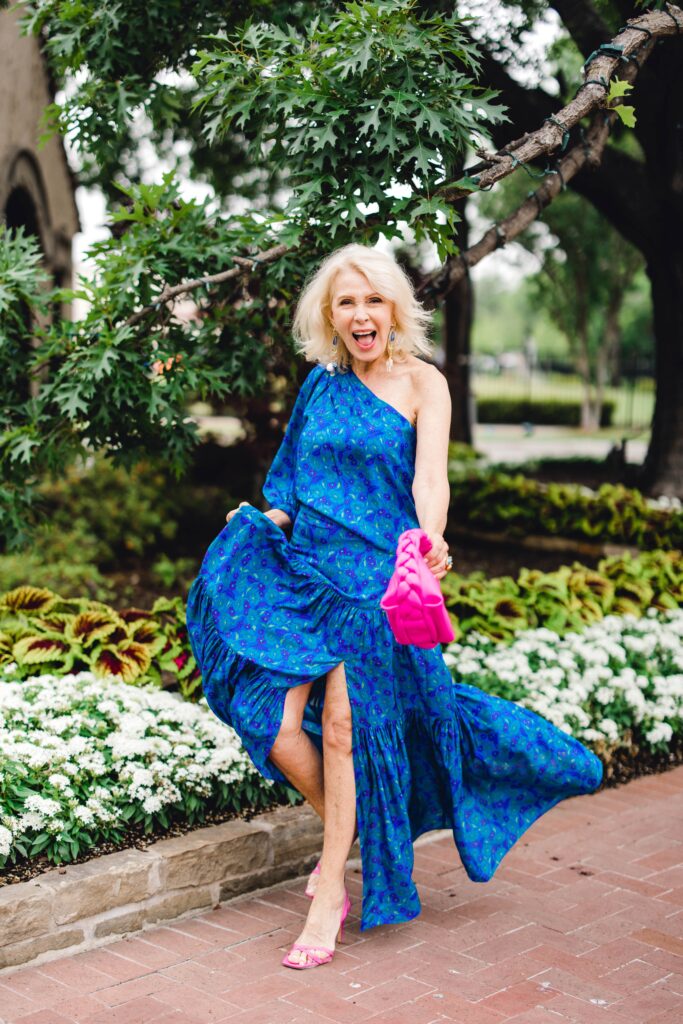 Smiling Dallas Blogger wearing beautiful top and skirt with pink accessories