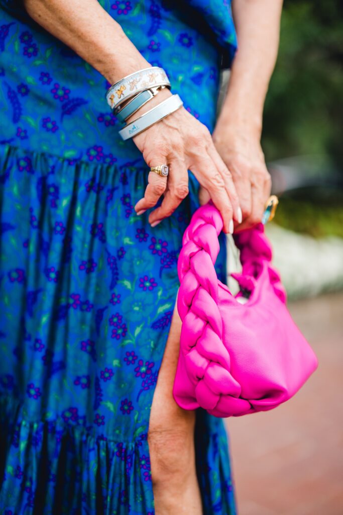 Style Beyond Age modeling jewelry and a pink handbag 