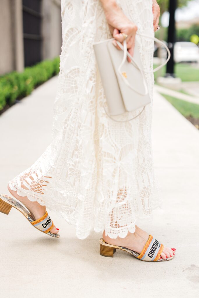 Close up of lace skirt and fashionable slides