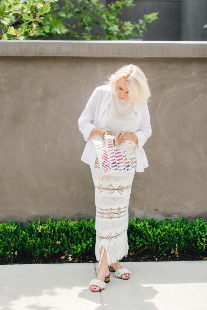 Woman wearing skirt and silk blouse looking in bag