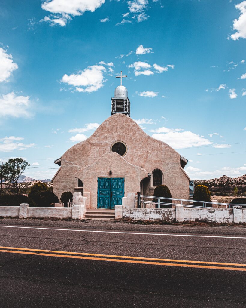 Old stone church in a desert with blue doors