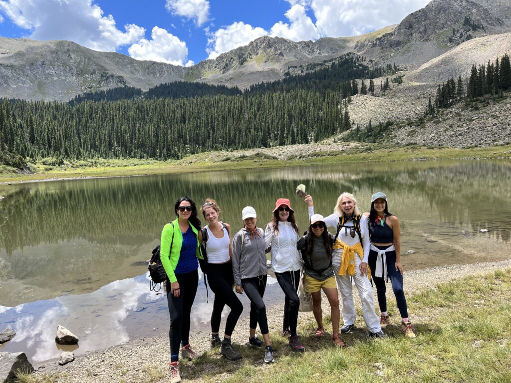 Group of women posing in front of Williams Lake