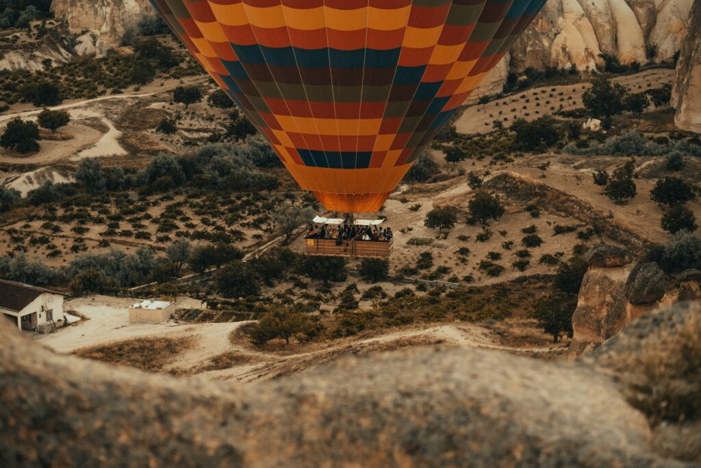 Hot air balloon flying over desert