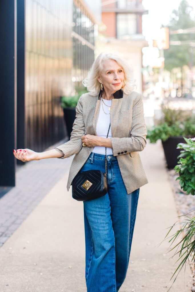 Woman walking in blazer and jeans how to Transition your Wardrobe from Summer to Fall