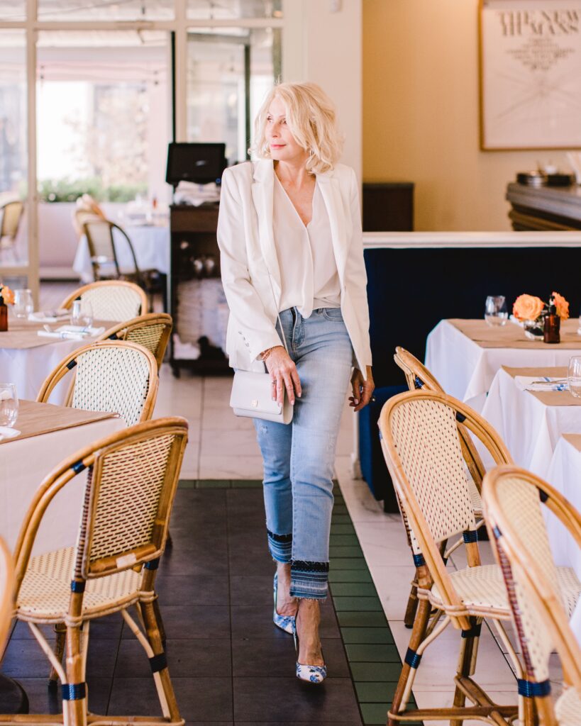 Sonia wearing jeans and white blazer