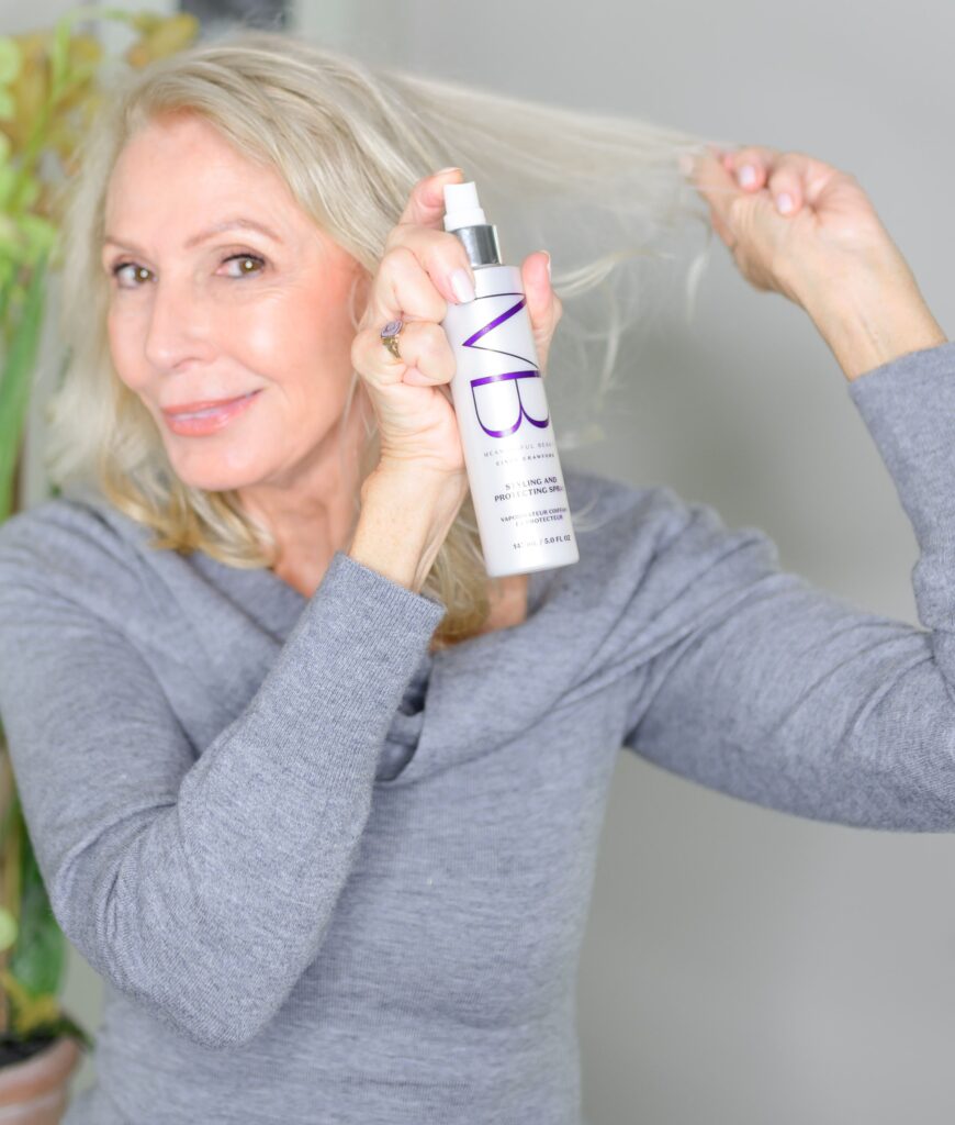 Style beyond age spraying Meaningful Beauty product onto hair