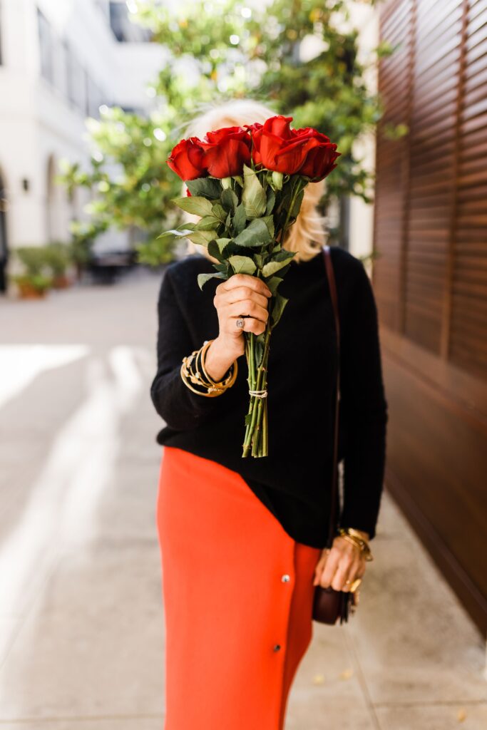 Woman holding bouquet of red roses for Valentines day